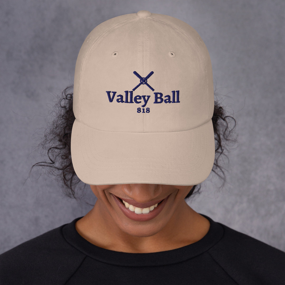 Valley Ball 818 Cream Dad Hat with navy crossed bats, worn